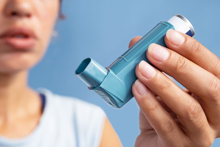 person holding an asthma inhaler
